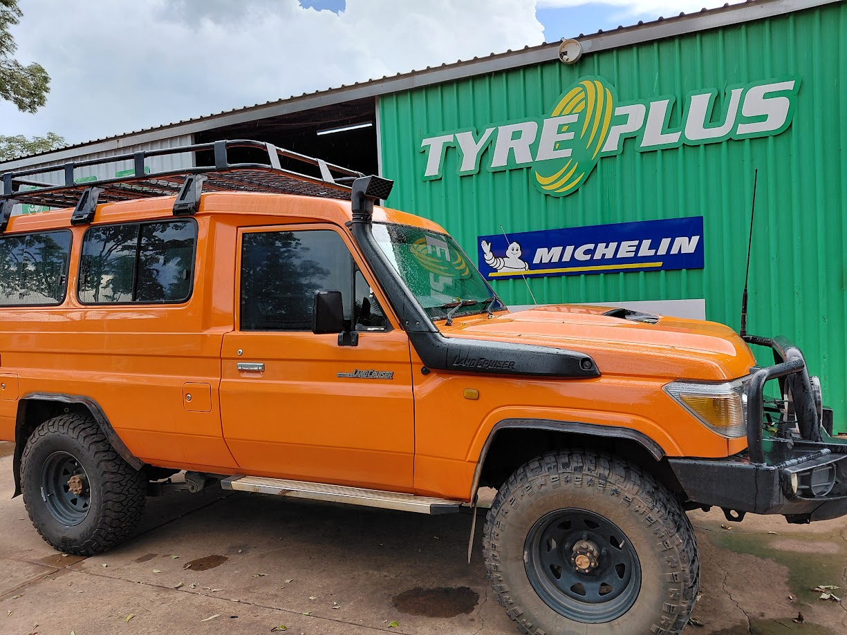 Orange Toyota Land Cruiser troop carrier parked in front of the Tyreplus Kununurra workshop