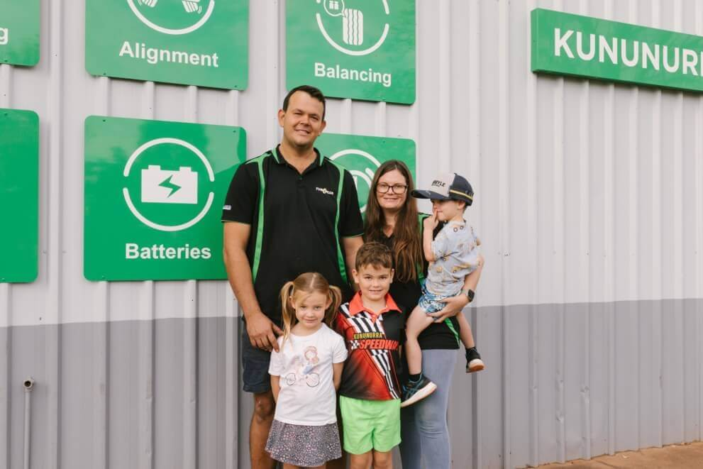 The family behind Tyreplus Kununurra in front of the workshop signage